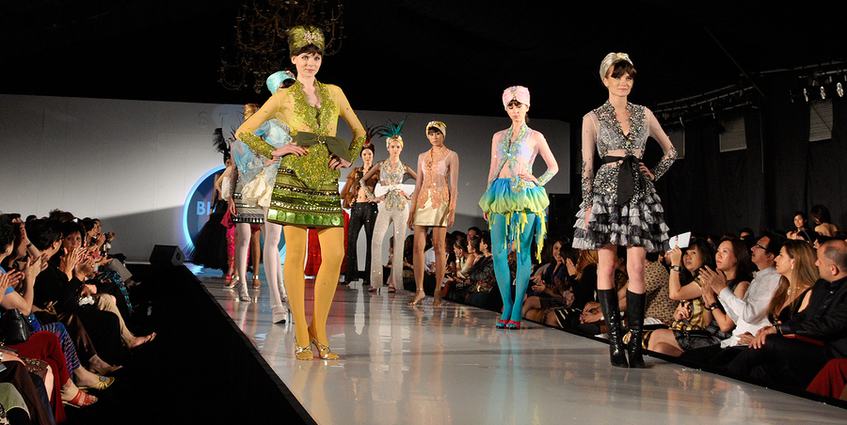 Models walking down the catwalk at a fashion show.