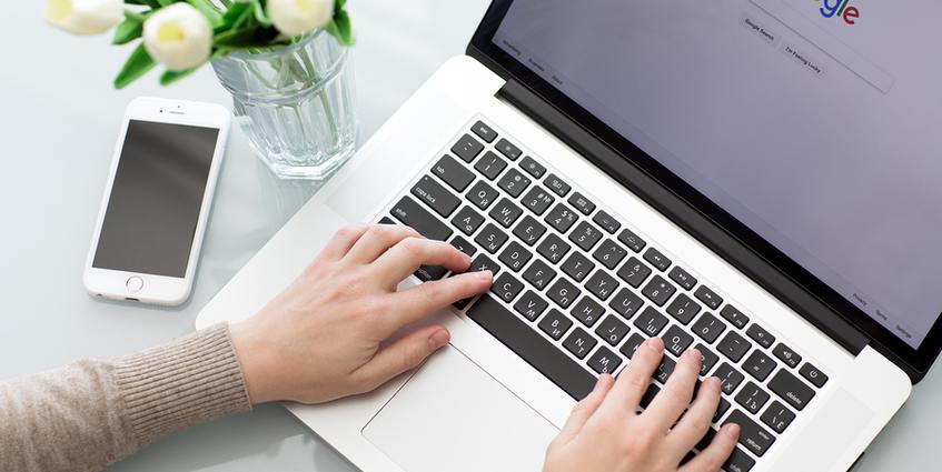 Person typing on a laptop.