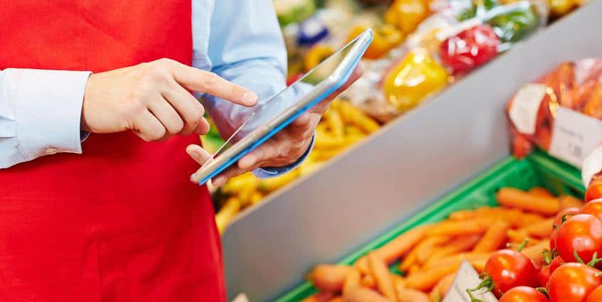 Person using their tablet at a grocery store.