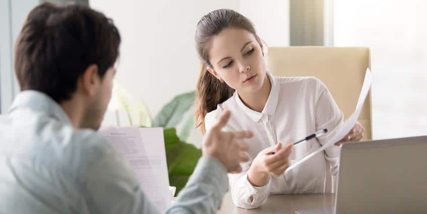 Woman going over a document with a male coworker.