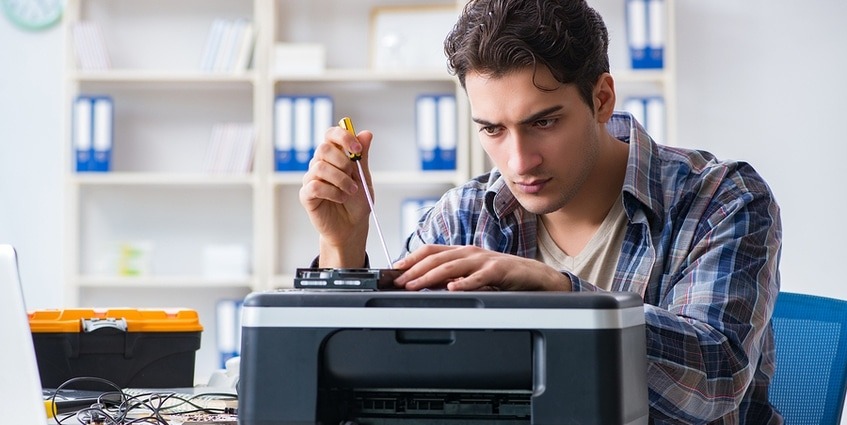 Technician fixing a printer.