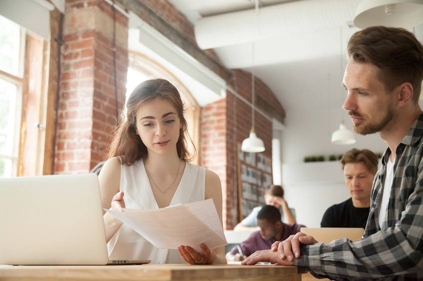 Woman and man looking at a document